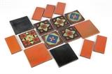 1049  A group of 16 ''Monaco'' California glazed ceramic tiles
Second quarter 20th century, some stamped ''Monaco'', some stamped ''Monaco / Santa Monica / Brick Co.'', others unsigned, comprising: 6 rectangular semi-gloss orange tiles (6'' H x 3'' W x .5'' D); 2 square semi-gloss orange tiles (6'' H x 6'' W x .5'' D); 2 square semi-gloss black tiles (6'' H x 6'' W x .5'' D); and 6 combination matte / glossy glazed polychrome tiles (5'' x 5'' x .75'' D), 16 pieces, est: $500/700

Provenance: Private Collection, Orange, CA.  Condition: Overall good condition. Each with varying degrees of craquelure to glaze. Scattered marks, scratches and chips (the largest 1'' x .25'').  Your bid indicates acceptance of our Conditions of Sale.  AS-IS.  ALL SALES FINAL