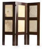 1050  A Mexican three-panel folding screen with inset carved alabaster panels
Mid 20th century, of three hinged mahogany panels, each inset with two square vertically-arranged alabaster panels carved to each face with pre-Columbian deities, 57'' H x 54.25'' W x 1.25'' D, est: $600/900

Provenance: Private Collection, Pasadena, CA.  Condition: Overall good condition. Minor sun fading to upper quarter of one side. One alabaster panel with a 3.5''-long diagonal crack to upper corner; another with a 2.25'' x 1'' area of fill to lower section of one face. Scattered areas of minor craquelure to wood finish. Flanking mahogany panels do not sit flush with floor; central mahogany panel with a 2''-long vertical split to top and four vertical splits to one leg (the longest approximately 12'').  Your bid indicates acceptance of our Conditions of Sale.  AS-IS.  ALL SALES FINAL