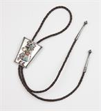 1059  An inlaid silver kachina bolo tie, Bennett
Circa mid-20th century, impressed fleur-de-lis mark, further marked ''Bennett / Pat. Pend. / C 31'' to slide, depicting a kachina dancer in polychrome stone inlay, with a braided leather tie terminating in silver tips with turned circular finials, 2.5'' H x 2'' W, est: $350/450

Condition: The tie: 36'' approximately. Overall good condition. General marks and tarnishing commensurate with age and use.  Your bid indicates acceptance of our Conditions of Sale.  AS-IS.  ALL SALES FINAL