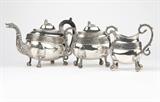 1086  A John Wesley Forbes coin silver tea service
Circa 1808 - 1838, New York, NY, maker's mark ''I.W.FORBES'' and further partially obliterated pictorial marks including a star and anchor, comprising: a teapot (7.75'' H x 13'' W x 5'' D), a covered sugar bowl (7.25'' H x 8.5'' W x 4.5'' D), and a milk jug (6.75'' H x 6'' W x 3.5'' D), each of oblong form with a gadrooned rim and foliate scroll band to body, 'S'-scrolled dolphin-form handles and leaf-capped ball-and-claw feet, the teapot and sugar bowl each with cover with recumbent lion finial, the teapot handle partially of ebony, 3 pcs, gross weight 65.3 oz troy tw approximately, est: $2000/2500

Provenance: Property of a Private Collection, Berkeley, CA.  Condition: Overall good condition. General marks, scratches, and tarnishing commensurate with age and use. Each piece with several small dings and folds scattered throughout body, ranging from minute to approximately .25'' diameter. The sugar bowl with a minute (.125'' wide) punc