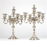 1091  A pair of Berry & Whitmore sterling silver 5-light candelabra
Late 19th / early 20th century, each marked to base ''Sterling / 1835 / Berry & Whitmore Co.'', each with a baluster-form standard surmounted by a removable scrolled finial, issuing four S-scroll arms each supporting an urn-form socket with a circular rocaille drip pan, raised overall on a shaped domed and stepped foot, weighted, 2 pieces, each: 22.75'' H x 16'' Dia., est: $2000/3000

Provenance: Private Collection, La Jolla, CA.  Condition: Overall good condition. General marks, scratches, tarnishing and rubbed wear commensurate with age and use. One with a .5'' x .25'' dent to side of central light and two smaller dents to upper portion of standard; rim of standard fitting slightly warped. The other with scattered shallow dings to sockets; the largest .25'' x .25'' approximately.  Your bid indicates acceptance of our Conditions of Sale.  AS-IS.  ALL SALES FINAL