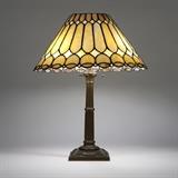 1140  A Duffner & Kimberly table lamp with leaded glass shade
First quarter 20th century, apparently unmarked, the patinated metal base model #3027, the square foliate-festooned base rising to a tapering columnar standard issuing three sockets, surmounted by a conical, scalloped edge ''Open Top'' leaded glass shade , 23.5'' H x 19'' Dia., est: $2000/3000

Literature: This base illustrated P. Crist, ''Mosaic Shades, Volume II'', Santa Fe Springs, 2005, p. 301.  Provenance: Private Collection, Fullerton, CA.  Condition: Overall good condition. Base with general marks, scratches and light wear commensurate with age. Chipping to patinated finish around base; the largest area 1'' x .25'' approximately. Scattered cracks to glass panels. Wiring should be checked by a qualified electrician prior to use.  Your bid indicates acceptance of our Conditions of Sale.  AS-IS.  ALL SALES FINAL