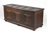 1145  An English oak lift-top blanket chest
19th century, the paneled hinged rectangular lift-top over a marquetry and strapwork-paneled body, raised on channeled ball feet, 28'' H x 65'' W x 21.5'' D, est: $1000/1500

Provenance: Private Collection, Palm Springs, CA.  Condition: General marks, scratches, minor losses, gouges and rubbed wear commensurate with age and use. Lock previously replaced; chipping and losses to timber surrounding previous lock's footprint. Evidence of woodworm. Splits and shrinkage cracks to timber. Added reinforcements to underside.  Your bid indicates acceptance of our Conditions of Sale.  AS-IS.  ALL SALES FINAL