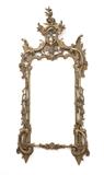 1160  A Rococo style giltwood wall mirror
19th century, the rectangular plate within a pierced C-scroll and rocaille carved surround with leafy vines climbing the columns on each side, the arched crest surmounted by flower heads, 66.5'' H x 31.5'' W x 5'' D, est: $1000/2000

Provenance: Property of an Estate, Montecito, CA.  Condition: General rubbed wear to gilding, revealing red bole and white gesso. Shrinkage cracks to timber. Nicks and a few losses to carved elements. Scattered repairs to carved elements. Flowers broken off of right-hand side of crest; the pieces retained. The mirror plate a later replacement. Wooden planks attached to rear of mirror frame with screws.  Your bid indicates acceptance of our Conditions of Sale.  AS-IS.  ALL SALES FINAL