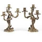 1164  A pair of French gilt bronze three-branch candelabra
Late 19th / early 20th century, each with three foliage-wrapped sockets with rocaille drip pans issuing from branch-form arms over a twisted standard supported by a shaped rocaille base, 2 pieces, each: 14'' H x 10'' W x 8'' D, est: $800/1200

Provenance: Private Collection, La Jolla, CA.  Condition: Overall good condition. General marks, oxidation and rubbed wear commensurate with age and use. Wear to gilding throughout. One with a .5''-long casting crack to base.  Your bid indicates acceptance of our Conditions of Sale.  AS-IS.  ALL SALES FINAL