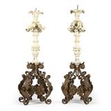 1183  A pair of Continental carved wood and gesso pricket candlesticks
19th century, each with a spire pricket surmounting a carved and gesso wood acanthus-decorated stem, raised on a scrolling quatrefoil wrought iron base adorned with floral medallions, 2 pieces, the first: 61.75'' H x 24'' Dia.; the second: 59.5'' H x 24'' Dia., est: $2000/3000

Provenance: Private Collection, La Jolla, CA.  Condition: General marks, scratches, chips and rubbed wear commensurate with age. Shrinkage cracks, splits to timber and cracking to gesso. Each with breaks and repairs to three acanthus leaves at stem. The second with two horizontal splits and subsequent repairs to stem and a 1'' loss to tip of one acanthus leaf near pricket.  Your bid indicates acceptance of our Conditions of Sale.  AS-IS.  ALL SALES FINAL