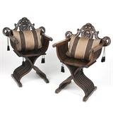 1188  A pair of carved walnut Renaissance revival Savonarola chairs
19th century, Italian, each of typical X-form, with a scrolling foliage-topped pierced removable backrest centered by a male portrait in profile, the arms terminating in rosettes modeled in the round, each accompanied by a later down-filled pillow, 2 pieces, each: 40.5'' H x 29.75'' W x 22.5'' D, est: $600/900

Provenance: Private Collection, La Jolla, CA.  Condition: Overall good condition; general scuffs, marks, scratches and wear commensurate with age. Each has been refinished, with some lightening to finish at feet due to probable water damage. Each with scattered chips and scuffs to legs. The first: With some sun fading. Interior notch to left side of backrest has been shaved down, most likely to ease removal due to shrinkage over time. Evidence of woodworm to slats and feet; a 2'' x .125'' loss due to insect damage to one slat. The second: Evidence of woodworm to slats; a .5'' x .125'' loss due to insect damage. 