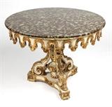 1190  A Continental gilt & white-painted center table
Late 19th / early 20th century, in the Italian Baroque style, the circular variegated stone top over a foliate-carved apron on a scrolled tripartite pedestal base, 31'' H x 39.5'' Dia., est: $1500/2500

Provenance: Property of an Estate, Montecito, CA.  Condition: Overall good condition. Structurally sound. Scratches to top. Typical nicks and stable shrinkage cracks to timber and wear to gilt and painted finish revealing white gesso and bare wood. Woodworm holes. A loss to timber at top of pedestal shaft. Finish probably refreshed at some point. The top a later replacement.  Your bid indicates acceptance of our Conditions of Sale.  AS-IS.  ALL SALES FINAL