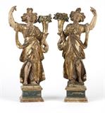 1191  A pair of Italian polychrome & gilt carved pine candelabra
Late 18th / early 19th century, each modeled as a draped female figure holding one arm aloft, the other arm supporting a flowering cornucopia-form candle arm, mounted to square plinth, 2 pcs, 21'' H, est: $1500/2000

Condition: Each with heavy rubbed wear and losses to polychrome and gilt decoration revealing bare wood. Shrinkage cracks, abrasions, nicks and chipped losses to timber. Woodworm holes throughout. Nail holes to plinths. Each with 2 - 3 glued repairs. One with a vertical split running the full length of figure and reinforced with iron pins.  Your bid indicates acceptance of our Conditions of Sale.  AS-IS.  ALL SALES FINAL