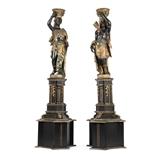 1209  Two polychrome-painted and gilt carved blackamoors on stands
Late 19th / early 20th century, likely Italian, one male and one female figure, each richly dressed, supporting a fruit-adorned basket atop their head; the male with a quiver of arrows, the female with a feathered fan, each standing contrapposto on a tripartite, columned base, raised on a conforming tripartite plinth, 2 pieces, each: 87'' H x 23.5'' Dia., est: $4000/6000

Provenance: Private Collection, La Jolla, CA.  Condition: General marks, scratches, shrinkage cracks, scattered chips and losses commensurate with age, including a localized area of paint loss to one face of male figure's base. Each with drilled holes to plinths for electrical wiring; the female with a corresponding .5'' x 2'' loss to surrounding veneer. Each with wiring now deficient. Breaks and repairs to female figure's arm at the shoulder, fingers, scepter, basket and head wrap.  Your bid indicates acceptance of our Conditions of Sale.  AS-IS.  ALL