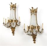 1208  A pair of gilt bronze and cut crystal five-light wall sconces
Late 19th / early 20th century, each of typical bag chandelier form, acanthus-crowned, with two tiers of suspended clear cut-crystal garlands, the central gilt bronze semi-circular support issuing five outswept foliate-scroll arms each topped by an urn-form light fitted with a faux candle; each drip pan suspending six clear cut-crystal drops, electrified, 2 pieces, each: 42'' H x 27'' W x 15'' D, est: $4000/6000

Provenance: Private Collection, La Jolla, CA.  Condition: Overall good condition. General marks, scratches and rubbing commensurate with age. Drilled for electricity, as stated. Crystals with scattered chips and nicks; the largest approximately .25'' x .5''. One lacking two crystal drops and with one broken garland (lacking one connecting crystal). The other with a slight bend to pendant. Each possibly lacking a decorative element to central support; dual screw holes visible.  Your bid indicates acceptance of 