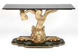 1211  A Continental carved gilt & painted wood console table
The base late 19th / early 20th century, the base of dolphin form on a shaped green faux marble plinth, with a later associated rectangular black stone top, 34.25'' H x 60'' W x 18'' D, est: $1500/2000

Provenance: Property of a Private Collection, Rancho Palos Verdes, CA.  Condition: Overall good condition. General marks, nicks, scratches and rubbed wear commensurate with age and use. Scattered losses to painted and gilt finishes. Shrinkage cracks to timber. Structurally sound. A minor nick to one corner of top. The top later and associated, as stated.  Your bid indicates acceptance of our Conditions of Sale.  AS-IS.  ALL SALES FINAL