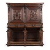 1216  A Continental carved walnut cabinet
19th century or earlier, the rectangular carved walnut case surmounted by a foliate molding centering a horned grotesque mask, over two locking paneled doors centering grotesque putti masks flanked by griffins enclosing a single adjustable shelf, over two short drawers with molded gargoyle-head pulls, over an associated rectangular base with paneled backboards and open gallery front, raised overall on a stepped beveled plinth, on bun feet, with key, 78.75'' H x 70'' W x 28.25'' D, est: $2000/3000

Provenance: Private Collection, La Jolla, CA.  Condition: General marks, scratches, gouges and shrinkage cracks commensurate with age. With added reinforcements to verso. Refinished. Upper and lower sections a marriage. Evidence of active woodworm. Horned grotesque lacking one horn. Repairs to molding on rightmost leg; a 2''-long portion of molding detached from leftmost leg (retained). Cabinet lock replaced.  Your bid indicates acceptance of our Cond