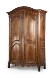 1217  A French Provincial double-door armoire
Second half 18th century, of carved walnut, the curving molded cornice surmounting two conformingly carved doors enclosing an open cabinet, over a rocaille apron, raised on scroll feet, 110'' H x 73.5'' W x 26.5'' D, est: $1000/2000

Provenance: Private Collection, La Jolla, CA.  Condition: Extensive woodworm throughout. General marks, scratches, chips and rubbing commensurate with age. Extensive shrinkage cracks and splits to timber throughout. Has been refinished; scattered remnants of previous orange paint visible in crevices, primarily localized to lower half. Hardware likely replaced. With added reinforcements to interior and cornice and scattered replaced portions of exterior elements including feet and a 6.25'' Dia. section to verso. The cornice with breaks and repairs. Lacking key.  Your bid indicates acceptance of our Conditions of Sale.  AS-IS.  ALL SALES FINAL
