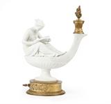 1219  A French biscuit porcelain lamp
Late 19th / early 20th century, inscribed ''Canova'', modeled after ''L'etude'' designed by Simon Louis Boizot (1743 - 1809 French), depicting a seated female figure reading atop an oil lamp, mounted with a gilt metal socket surmounted by a gilt flambeau finial on an oval base, previously electrified, 15'' H x 12.5'' W x 5.25'' D, est: $1500/2500

Provenance: Private Collection, La Jolla, CA.  Condition: Overall good condition. With general marks, scratches and rubbing commensurate with age. Lacking foliate margents to socket. Socket and finial detached from mount. Fleabite chip to edge of porcelain base. Floral swags on base have been shortened to accommodate on/off switch. Base with a gilt rosette covering hole for cord.  Your bid indicates acceptance of our Conditions of Sale.  AS-IS.  ALL SALES FINAL