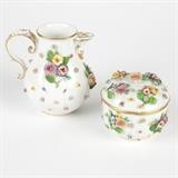 1223  A Meissen coffee pot & sugar bowl
Mid 20th century, each with underglaze blue crossed swords mark, each decorated with polychrome-painted applied flowers on a white ground with gilt highlights, the sugar bowl with rosebud finial, 2 pcs, the coffee pot: 5.5'' H x 5.25'' W x 4''D; the sugar bowl: 3.75'' H x 3.825'' Dia., est: $400/600

Condition: Each with scattered small chips to edges of applied flowers and leaves. Each with some larger losses to stems and leaves. Coffee pot lacking lid.  Your bid indicates acceptance of our Conditions of Sale.  AS-IS.  ALL SALES FINAL