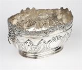 1250  A Victorian sterling silver monteith, Daniel & John Wellby 
1890, London, with maker's mark ''DWJW'' within a rectangle, the oval bowl with a chased and repousse-decorated floral and rocaille rim with female masks and cherubs at each side and end, over a gadrooned foliate body flanked by lion's head ring handles, monogrammed to one reserve ''RSB'', raised on a spreading oval foot, 8'' H x 15.5'' W x 11'' D, 68.980 oz troy approximately, est: $2000/3000

Provenance: Private Collection, La Jolla, CA.  Condition: Overall good condition. General light marks, scratches, dings and tarnishing commensurate with age and use, including three minor dings around base of bowl. A 1'' x 3'' area of scratching to bottom of bowl interior. Monogrammed, as stated.  Your bid indicates acceptance of our Conditions of Sale.  AS-IS.  ALL SALES FINAL