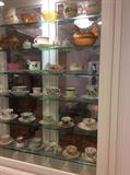 One of many cases of fine china and porcelain cups and saucers. A remarkable collection! 