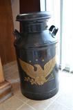 Milk can with early American motif.