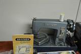Brother sewing machine with accessories and case.