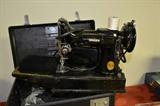 Portable vintage Singer Featherweight sewing machine model 221 with carrying case and accessories