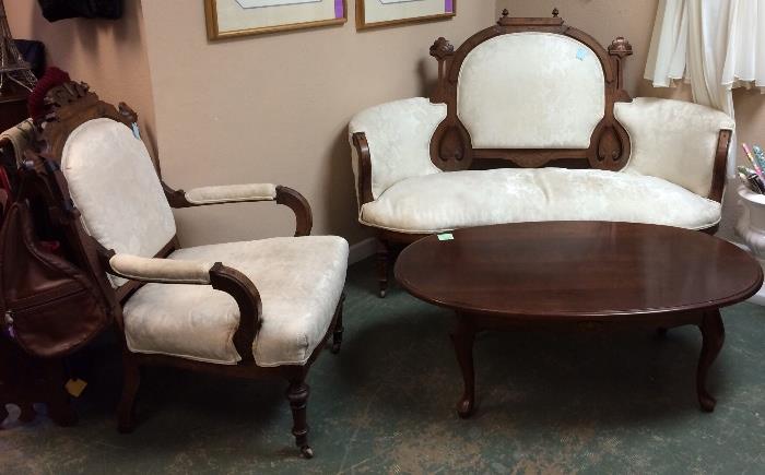 Eastlake settee and chair and oval coffee table.