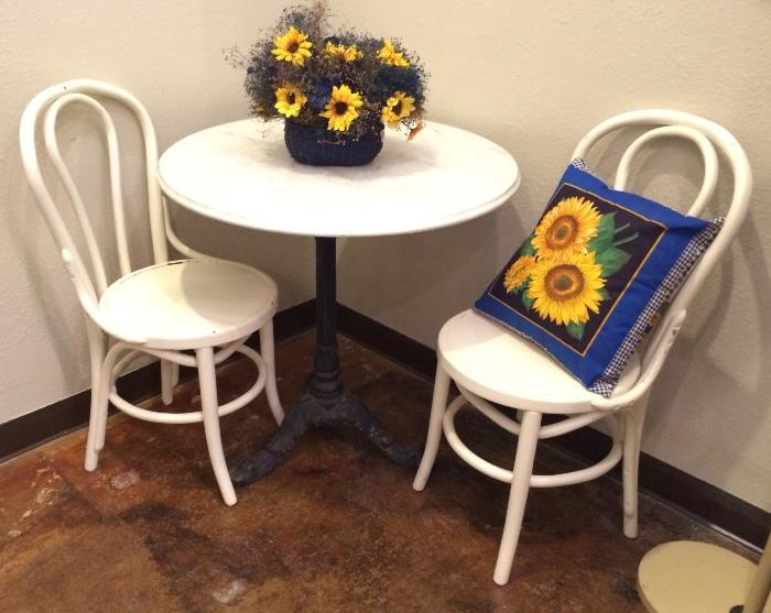 Marble topped and wrought iron bistro table and pair white vintage "sweetheart" chairs.