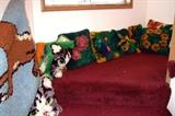 many hooked cushions & rugs