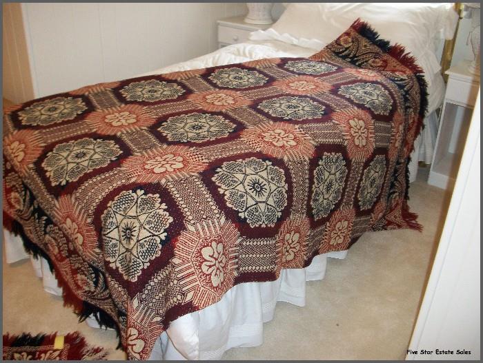 A very old mint- condition red, white, and blue coverlet. There are 3 of these - one has a Christmas theme.