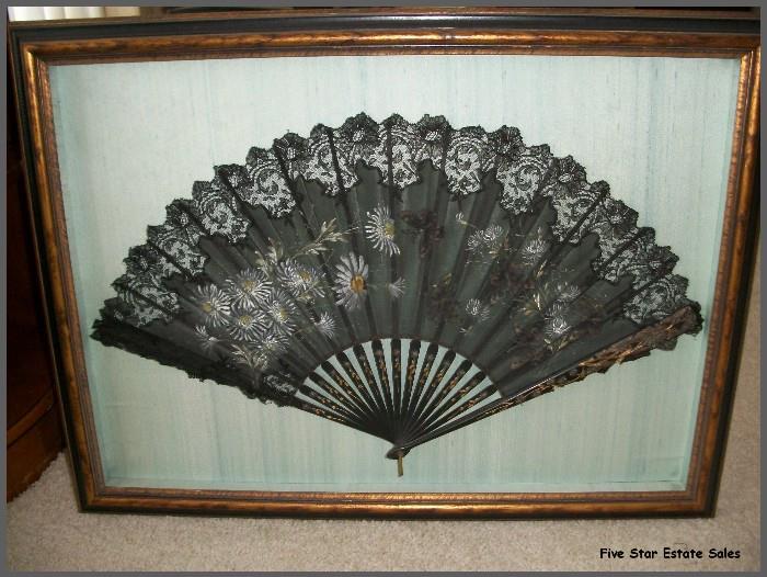 A framed antique hand-painted fan.