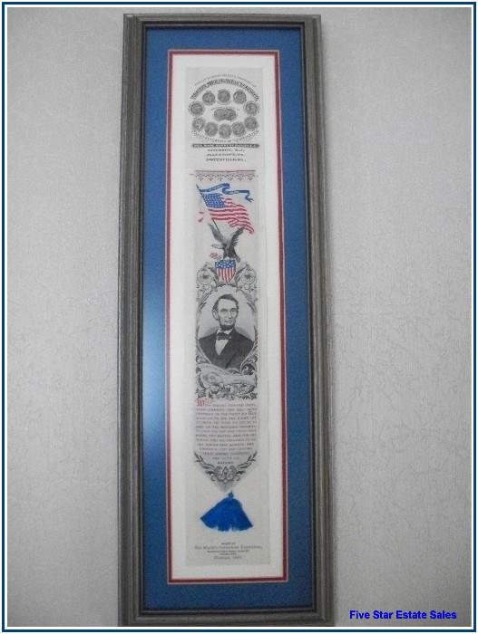 A framed silk bookmark, "Woven at the Worlds Columbian Exposition Machinery Department Annex 28, Chicago 1893"