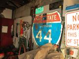 TONS OF SIGNS GARAGE FULL