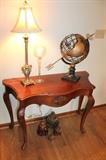 Console table, lamp, metal globe sculpture