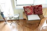 Wicker stool, small glass-top table, and home decor