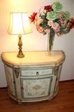Painted console cabinet, lamp, and flower arrangment