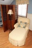Upholstered chaise lounge, floor lamp, and room divider screen