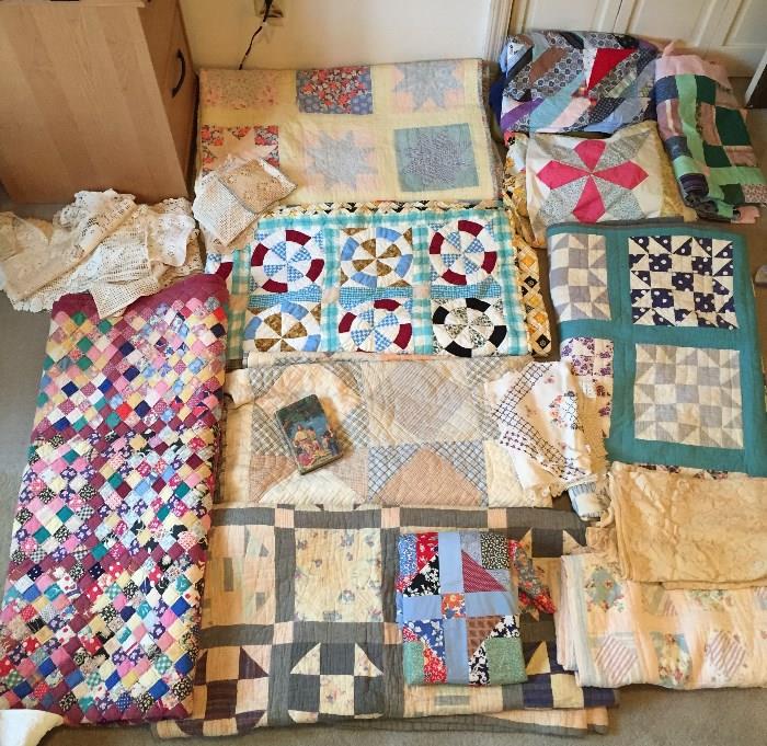 Various old Quilts, and  pieced fabrics ready for final quilting