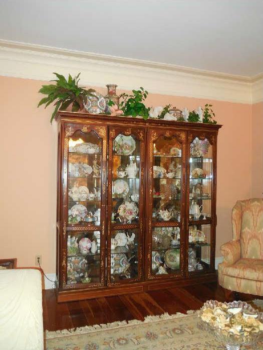 Mahogany Curio full of a large variety of collectibles.