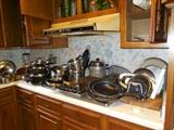 Kitchen full of pots and pans, 10 cast iron skillets, new set of cookware.