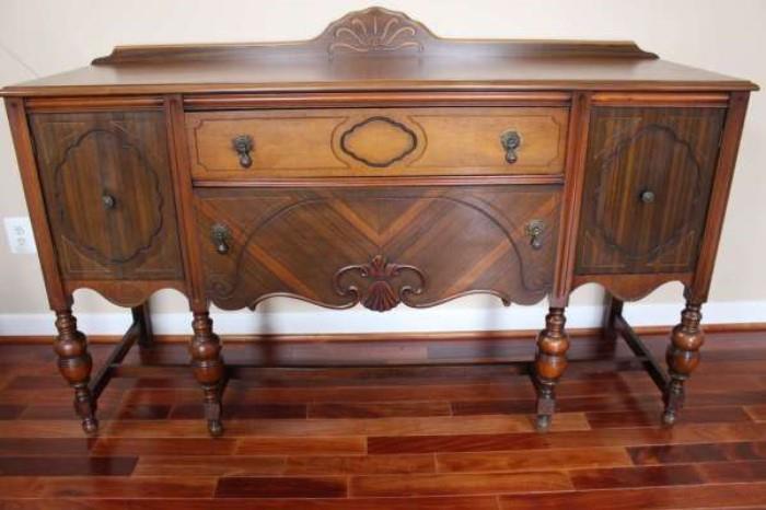 There are several lovely antiques, like this fine inlaid sideboard.