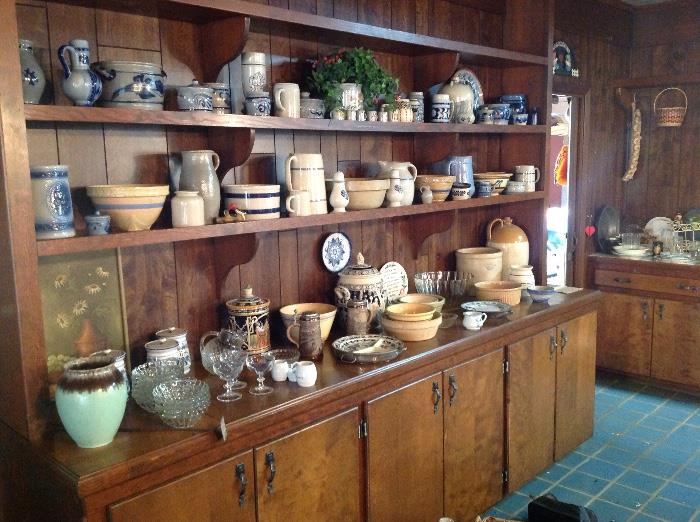 a cabinet full of crockware, pottery, salt glaze american and german salt glaze with lots of interesting items