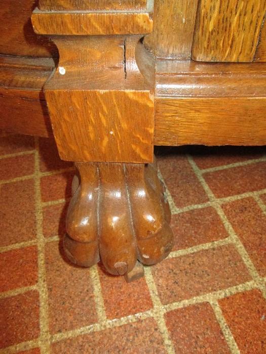 Close up of Lion's paw feet on oak china cabinet