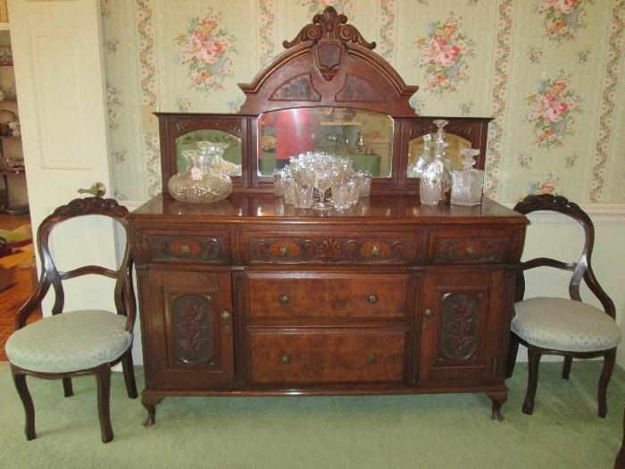 Carved, burled wood mirrored buffet, 2 of 5 deeply carved fruit crest chairs
