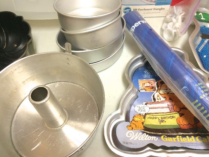 Wilton egg-shaped pans, Garfield cake mold, tube pan, Tupperware rolling mat never opened(some has already sold)
