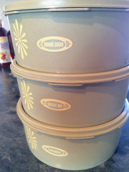Tupperware avocado canister set with "brown sugar," "biscuit mix," and "cormeal" lables
