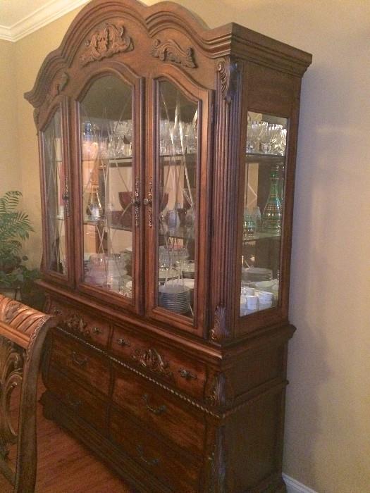 Samuel Lawrence china cabinet with three glass-front doors, mirrors, lighting, and six large drawers