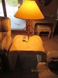Though this picture isn't great, it shows the matching end table to the coffee table and a wrought iron lamp