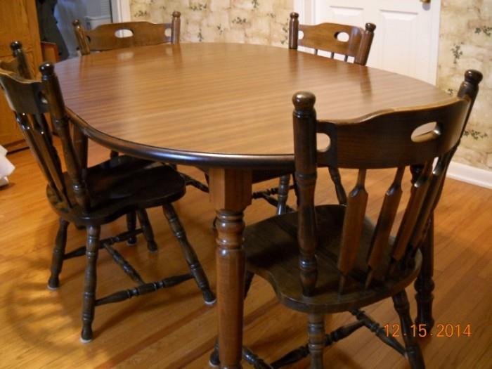 Wood table with two leaves and 5 chairs.