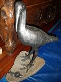 crane statue--notice the carved legs of the armoire