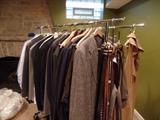 Racks of men's suits, belts, slacks etc